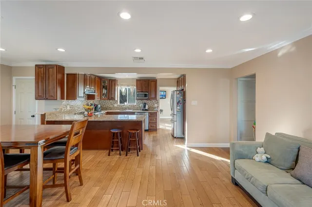 a view of a dining room with furniture and wooden floor