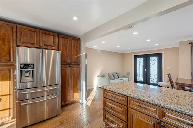 a kitchen with stainless steel appliances granite countertop a refrigerator and a sink