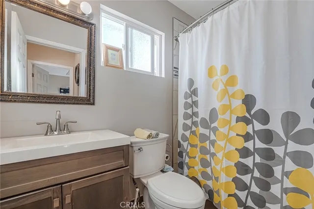 a bathroom with a toilet a sink and a mirror