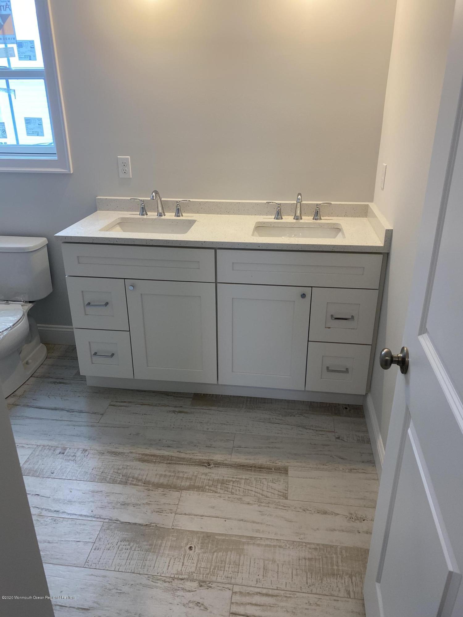 2203 Rogers Road Point Pleasant, NJ 08742 - Photo 7 of 8 a bathroom with a sink and a mirror