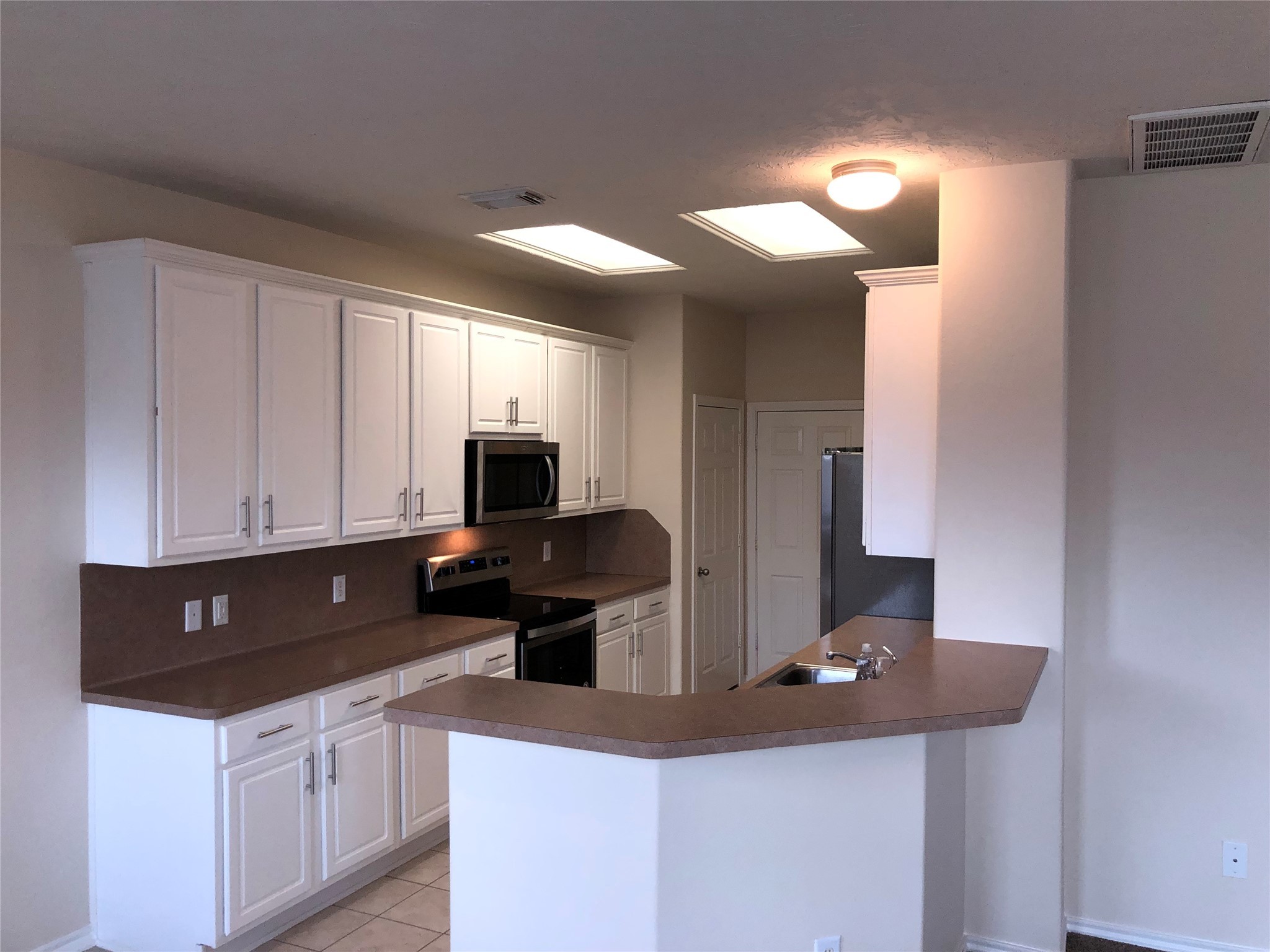 5639 Stonecloud Lane Katy, TX 77494 - Photo 8 of 43 Incredible kitchen with recently added built-in microwave, refrigerator, dishwasher & stove! There are two pantries, a huge breakfast bar, plenty of cabinets, and easy to keep clean tile floors.