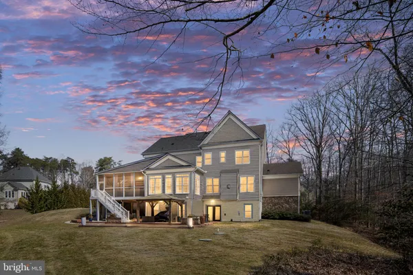 a front view of a house with yard and green space