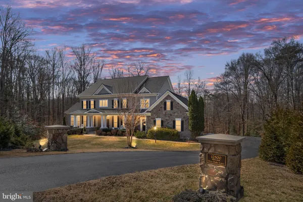 an aerial view of a house with a yard and large tree