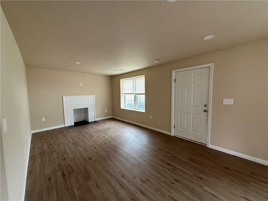 620 East Orr Street Anderson, SC 29621 - Photo 17 of 22 This inviting space features durable flooring and a cozy fireplace, creating a warm atmosphere.