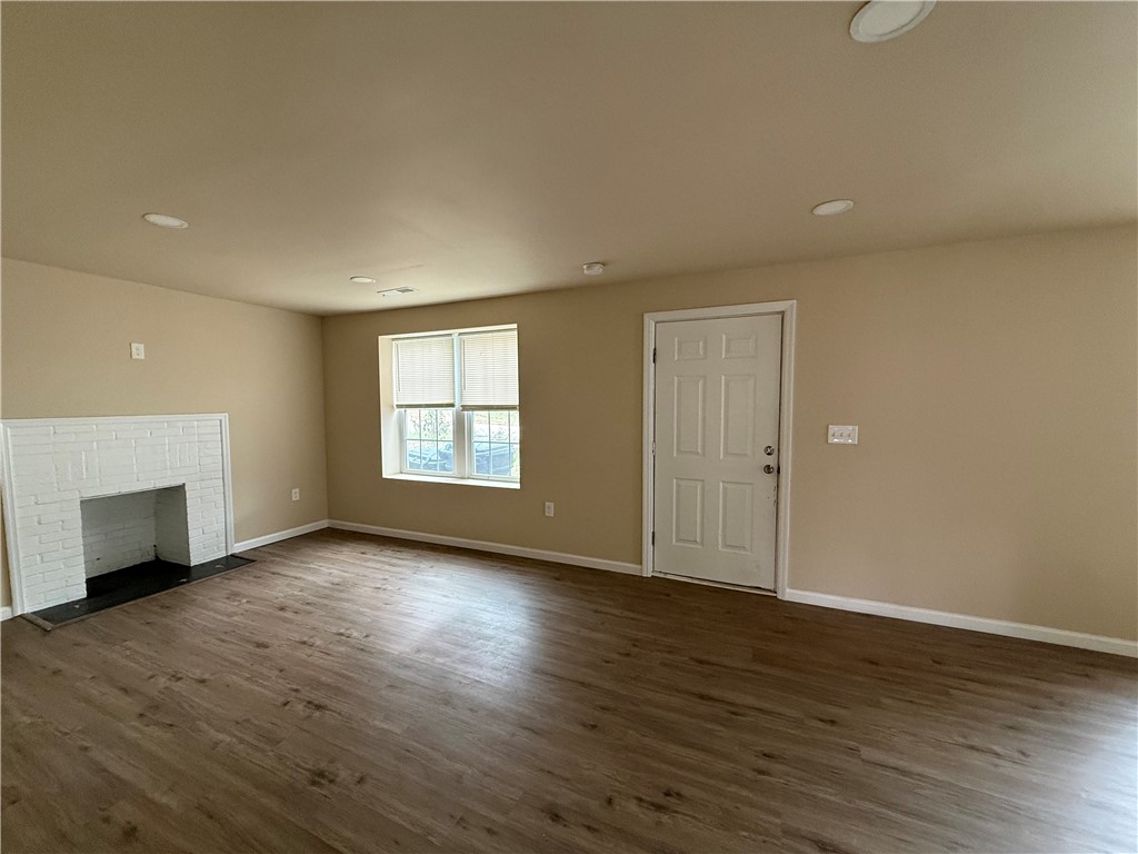 620 East Orr Street Anderson, SC 29621 - Photo 18 of 22 This inviting living space features warm flooring, a charming fireplace, and a welcoming entrance.