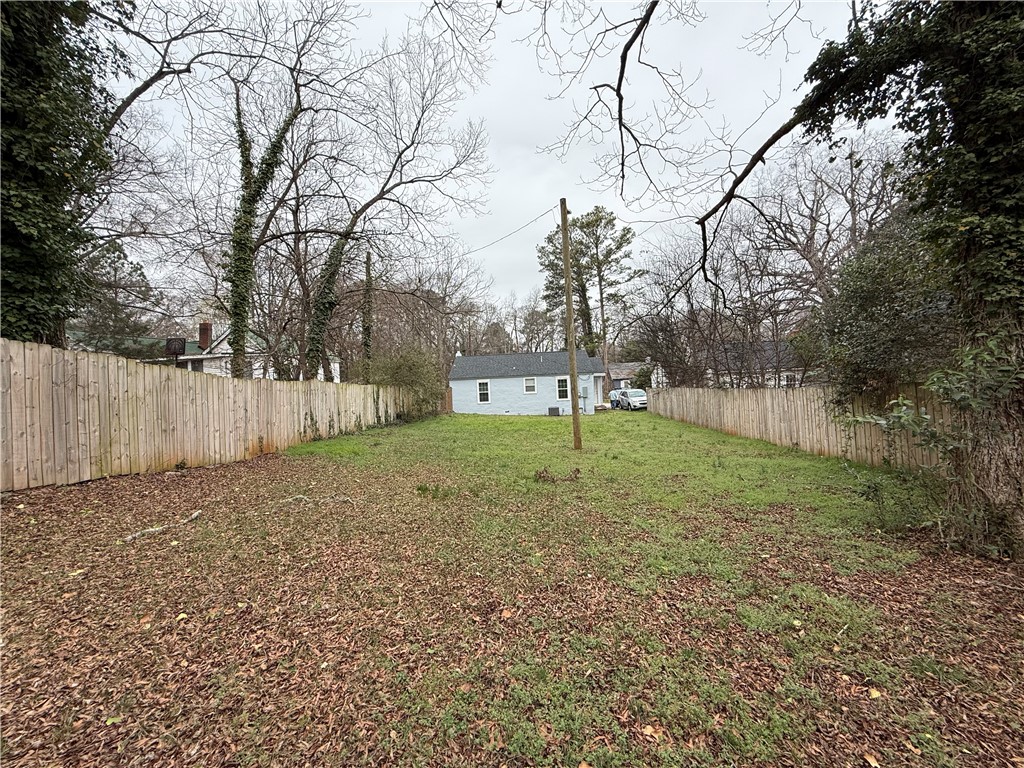 620 East Orr Street Anderson, SC 29621 - Photo 3 of 22 This spacious yard offers ample outdoor living potential, framed by a classic wood fence.