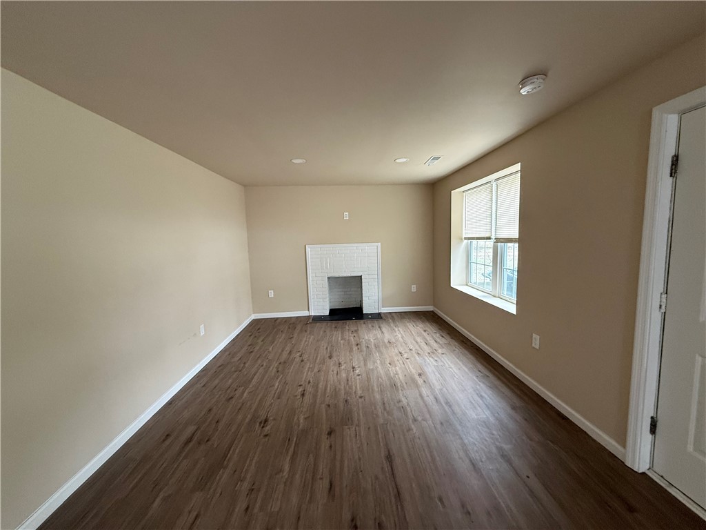 620 East Orr Street Anderson, SC 29621 - Photo 6 of 22 This inviting space features durable flooring and a charming fireplace, perfect for cozy gatherings.