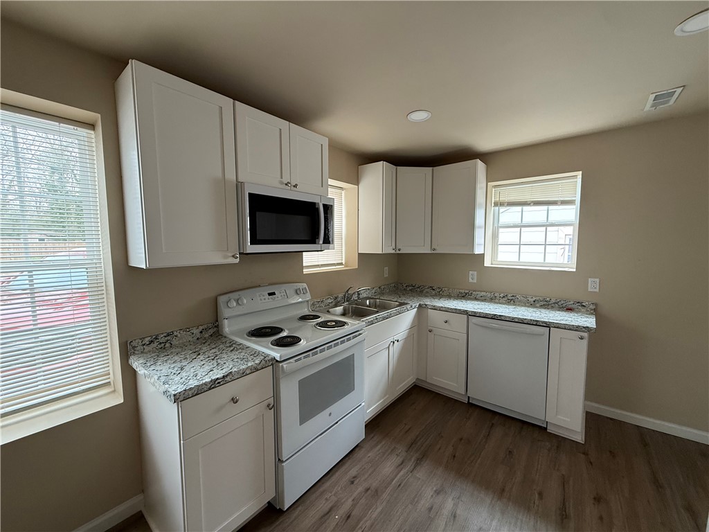 620 East Orr Street Anderson, SC 29621 - Photo 7 of 22 This modern kitchen features crisp cabinetry and durable countertops, offering a clean and functional design.