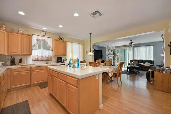 a kitchen that has a lot of cabinets a sink and a wooden floor in it