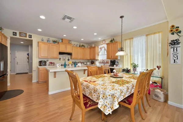 a large kitchen with a table and chairs