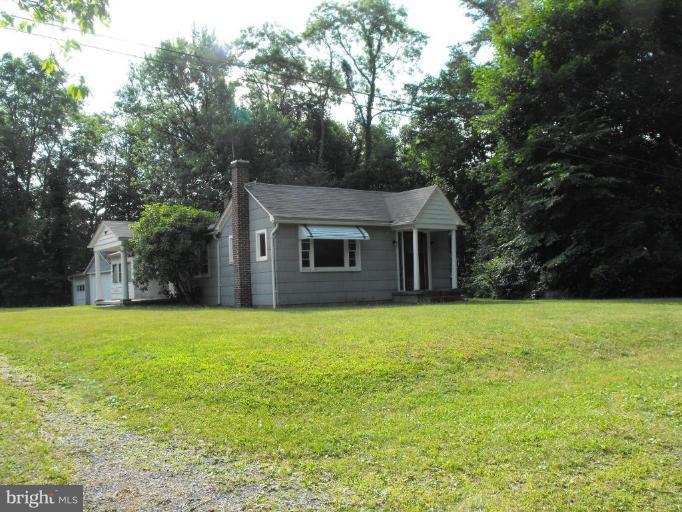 116 Paw Paw Road North Bloomery, WV 26817 - Photo 2 of 16 a front view of a house with a garden