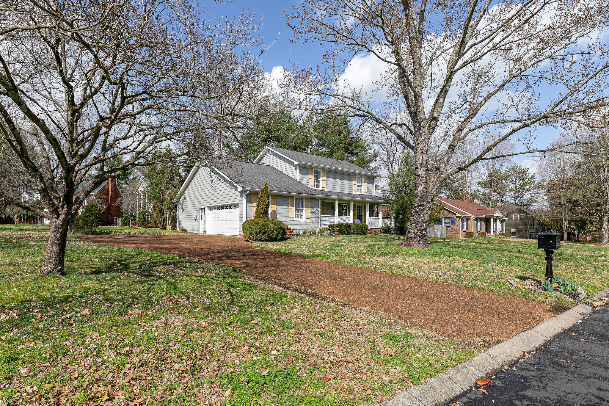 212 Gloucester Street Franklin, TN 37064 - Photo 2 of 23 a view of a yard in front of a house with large trees