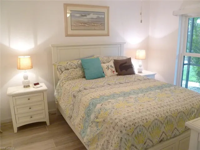 a large bed sitting in a bedroom next to a lamp