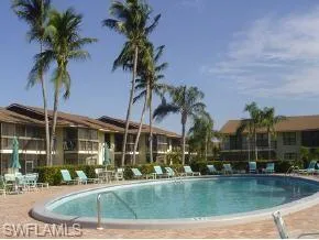 a view of a house with swimming pool and a sitting area