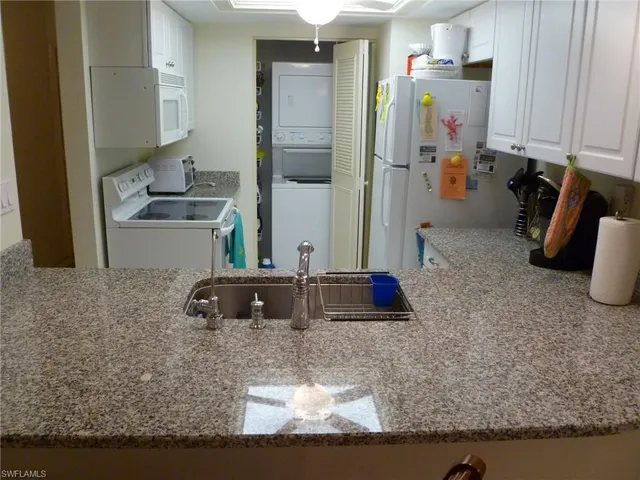 a kitchen with a sink and a stove top oven
