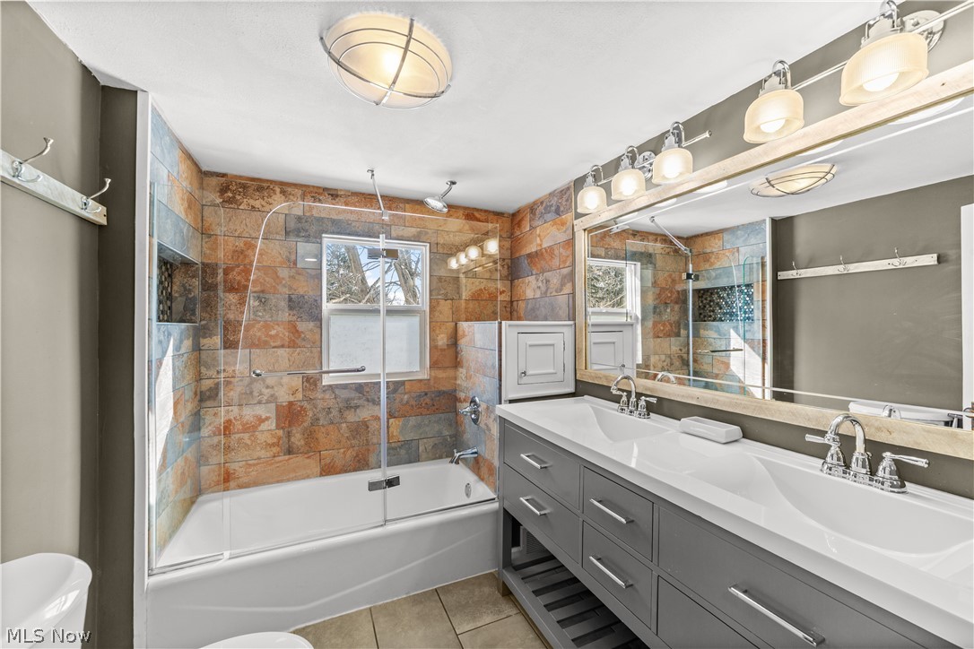 4609 Middle Ridge Road Perry, OH 44081 - Photo 17 of 27 Full bath featuring double vanity, a combined bath / shower with rainfall shower, and light tile patterned floors