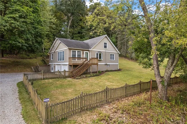 a view of a house with swimming pool next to a yard