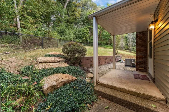 a house view with a sitting space fire pit and outdoor space