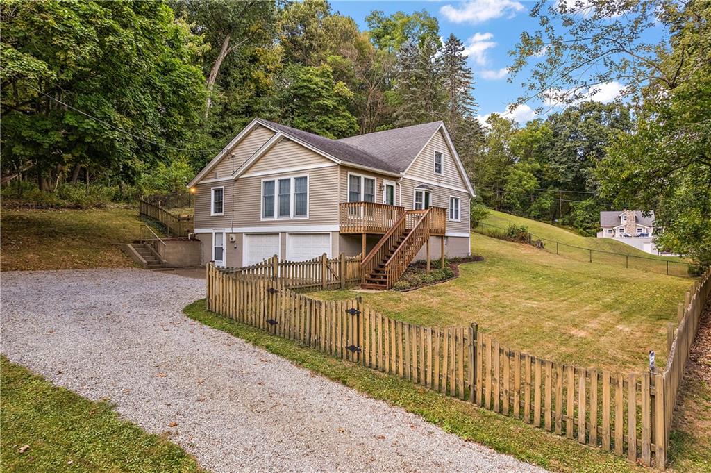 4792 Wexford Run Road Bradford Woods, PA 15015 - Photo 12 of 27 a view of a house with a small yard and large trees