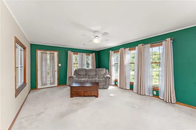 a living room with furniture and large windows