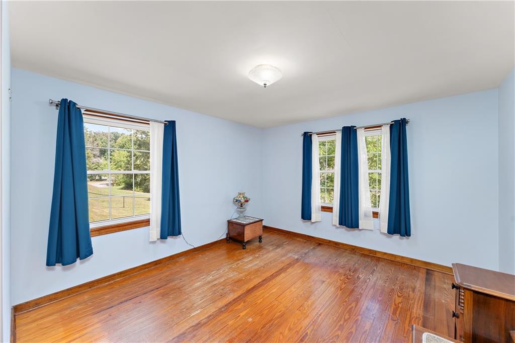 4792 Wexford Run Road Bradford Woods, PA 15015 - Photo 20 of 27 a view of an empty room with wooden floor and a window