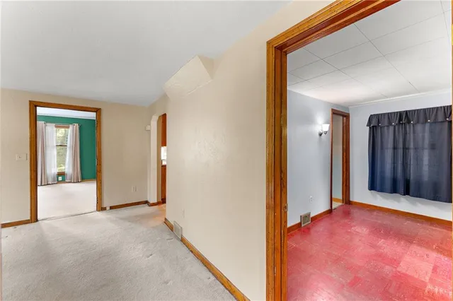 an empty room with closet and mirror