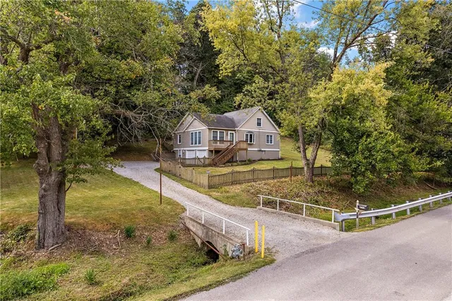 a view of a swimming pool with a patio and a yard