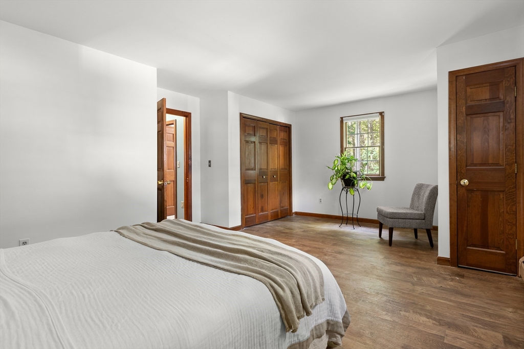 31 Kimball Road Amesbury, MA 01913 - Photo 17 of 40 a bedroom with a bed and a chair