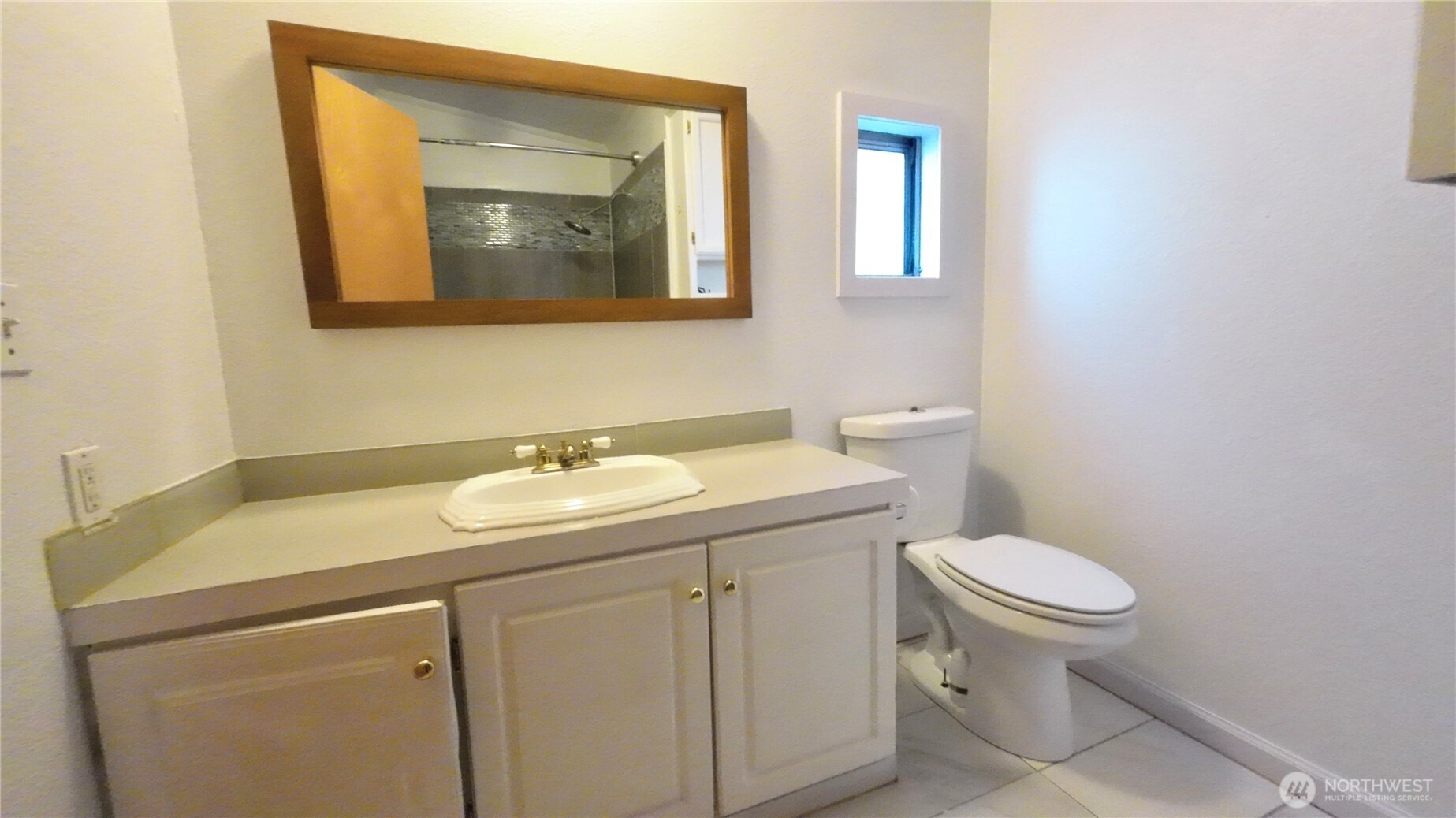 4672 Birch Bay Lynden Road, Unit 82 Blaine, WA 98230 - Photo 16 of 22 a bathroom with a toilet sink and mirror