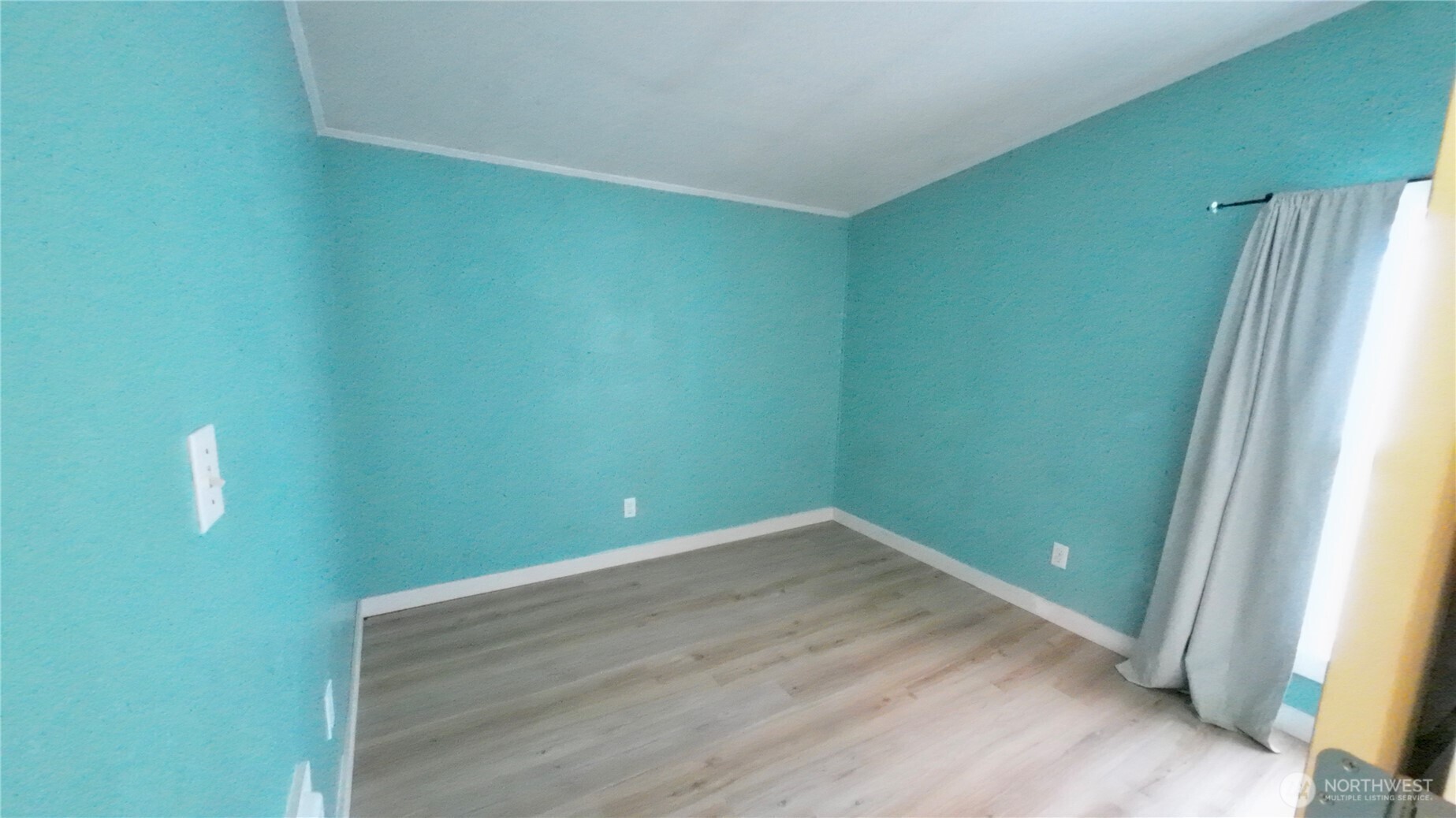 4672 Birch Bay Lynden Road, Unit 82 Blaine, WA 98230 - Photo 22 of 22 a view of a room with wooden floor and a window