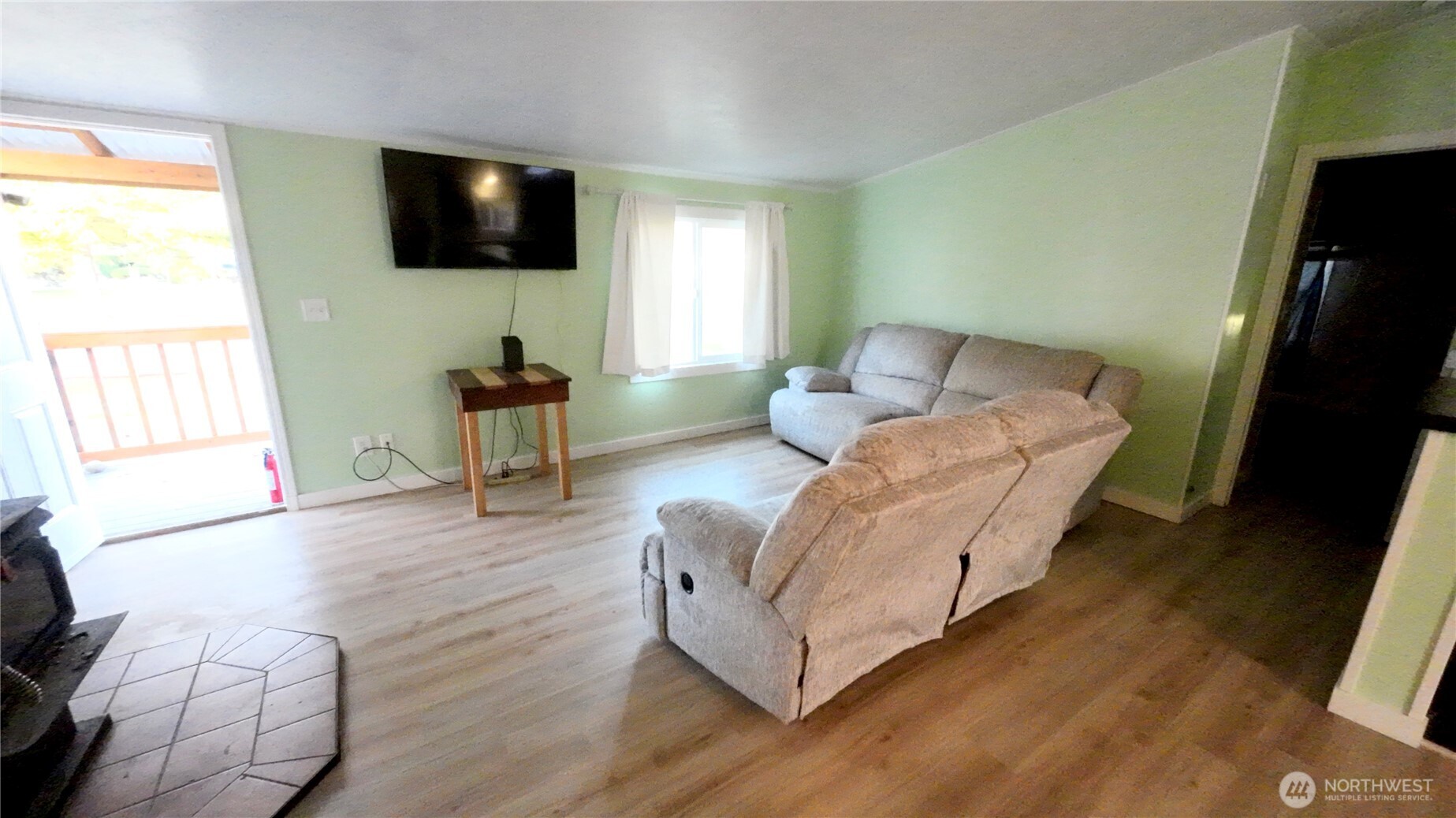 4672 Birch Bay Lynden Road, Unit 82 Blaine, WA 98230 - Photo 5 of 22 a living room with furniture and a flat screen tv