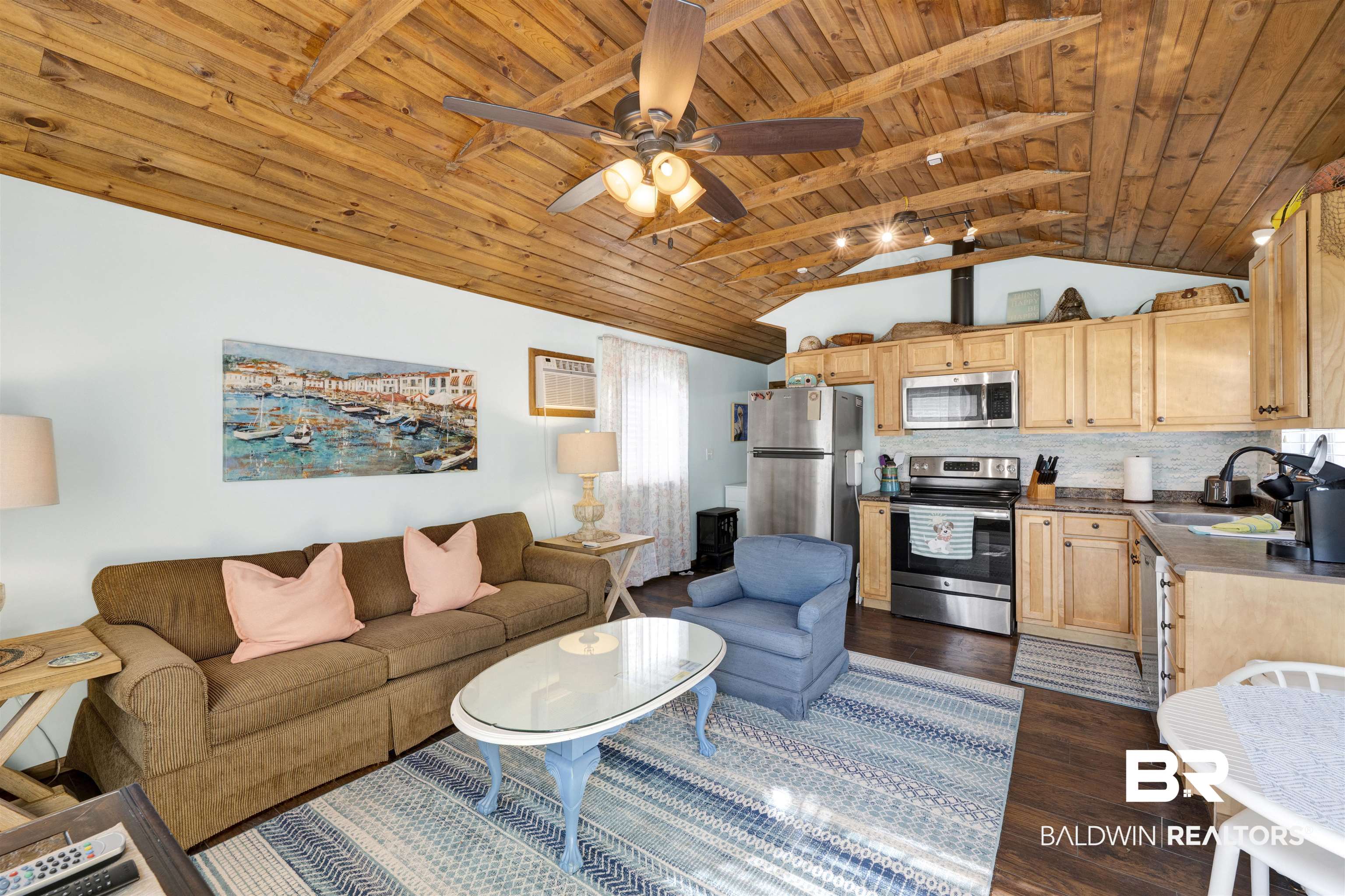 23770 Miflin Road Elberta, AL 36530 - Photo 28 of 38 Living area with dark wood finished floors, wooden ceiling, vaulted ceiling, a wall unit AC, and a ceiling fan