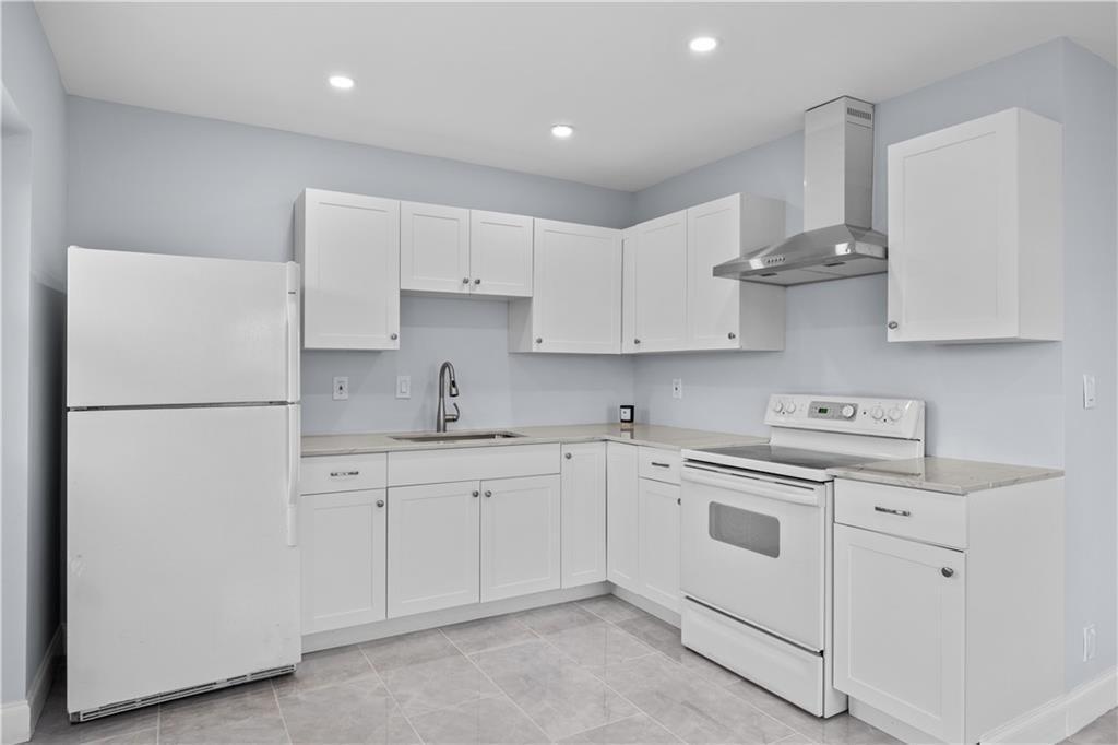 260 Northwest 19th Street, Unit 290 Boca Raton, FL 33432 - Photo 6 of 18 a kitchen with white cabinets and white appliances