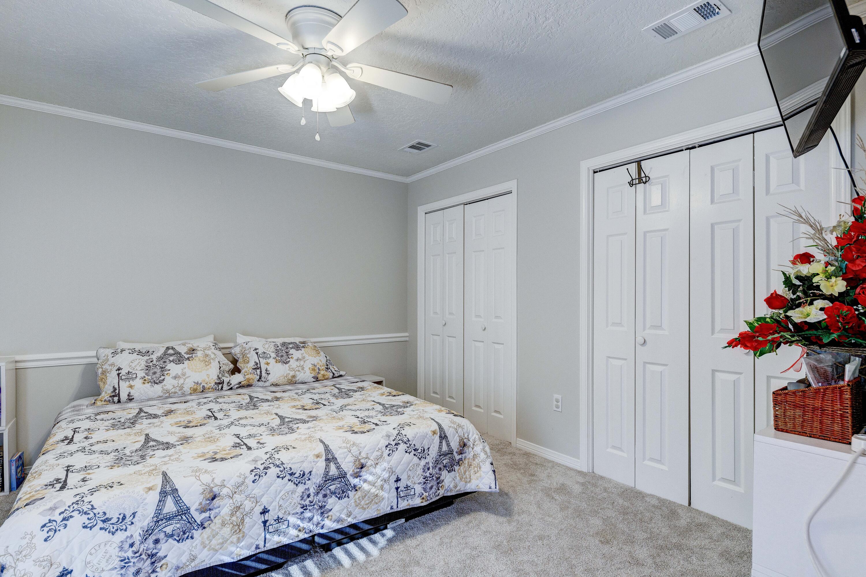 104 Fairoaks Drive Crestview, FL 32539 - Photo 13 of 24 a bedroom with a bed and a chandelier