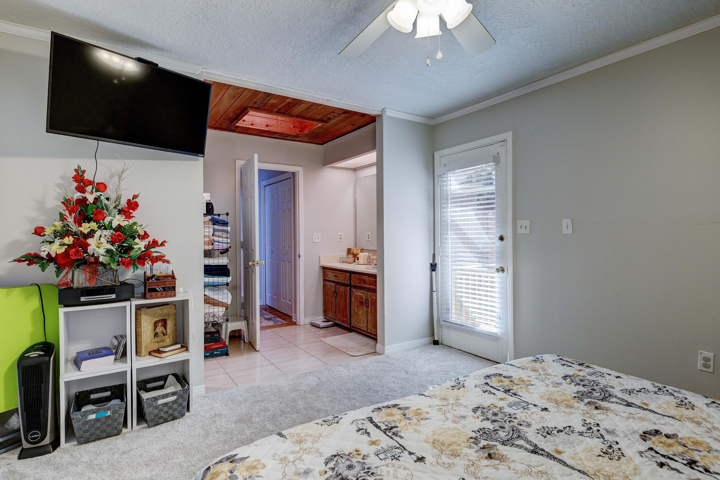 104 Fairoaks Drive Crestview, FL 32539 - Photo 14 of 24 a bedroom with furniture and a flat screen tv