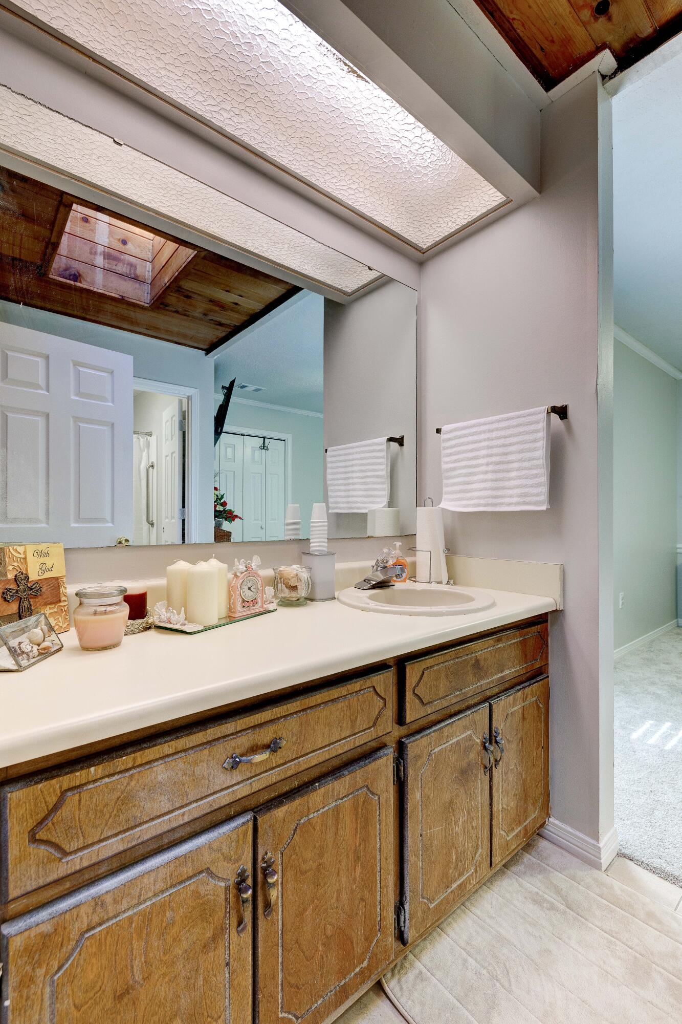 104 Fairoaks Drive Crestview, FL 32539 - Photo 16 of 24 a bathroom with a sink and a mirror