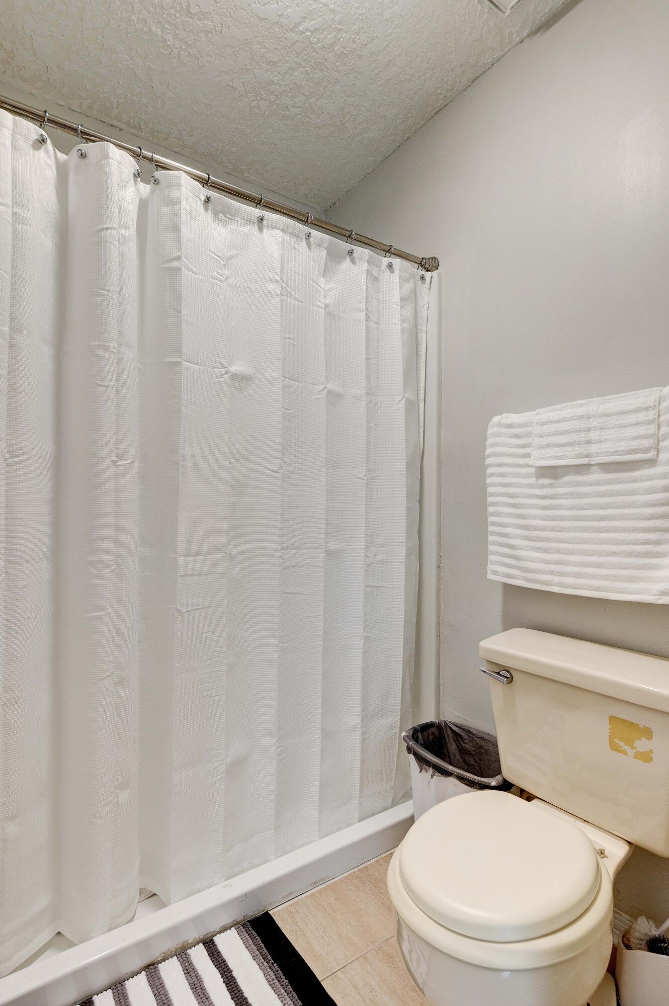 104 Fairoaks Drive Crestview, FL 32539 - Photo 17 of 24 a white toilet sitting next to a shower curtain