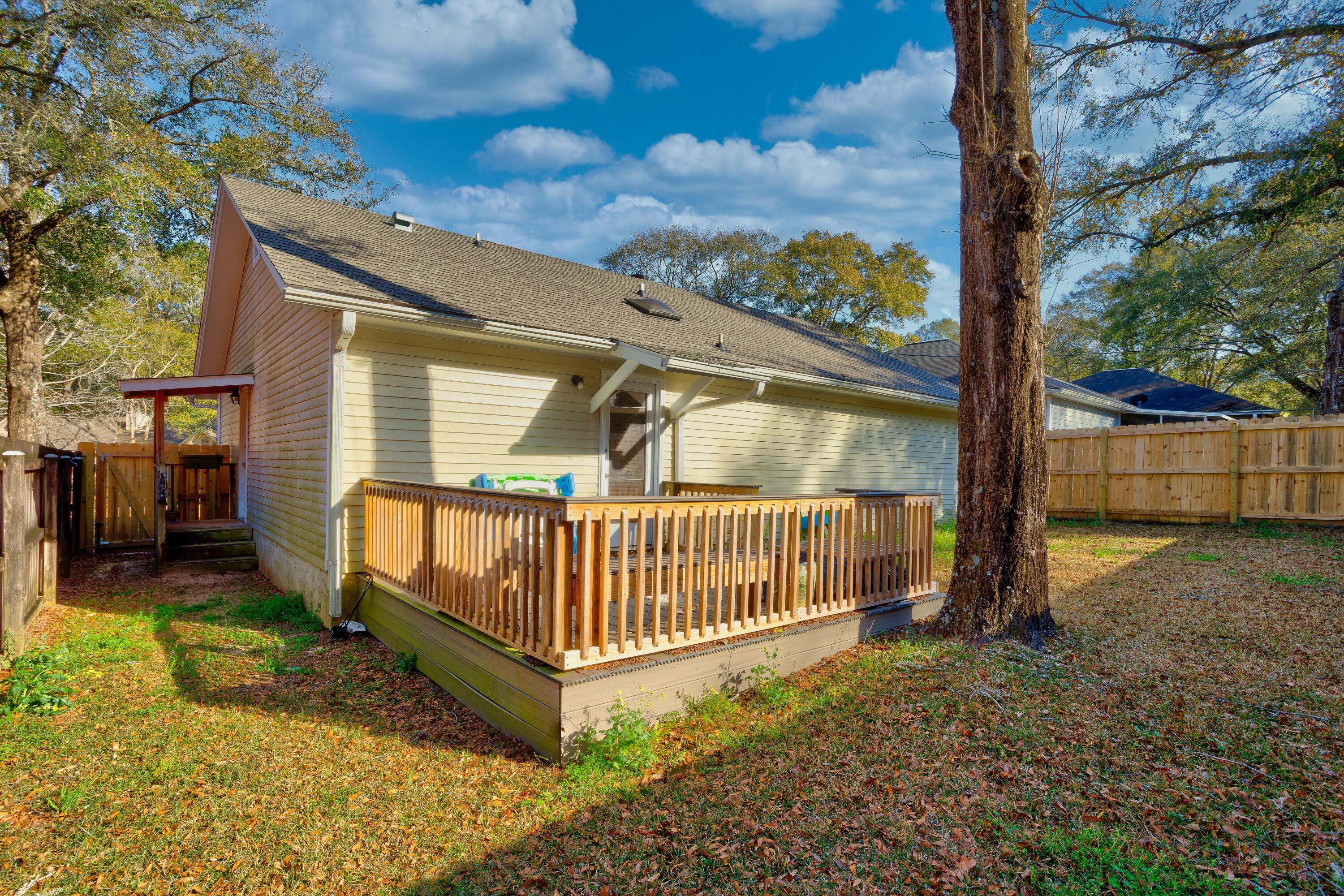 104 Fairoaks Drive Crestview, FL 32539 - Photo 23 of 24 a view of backyard with a garden and deck