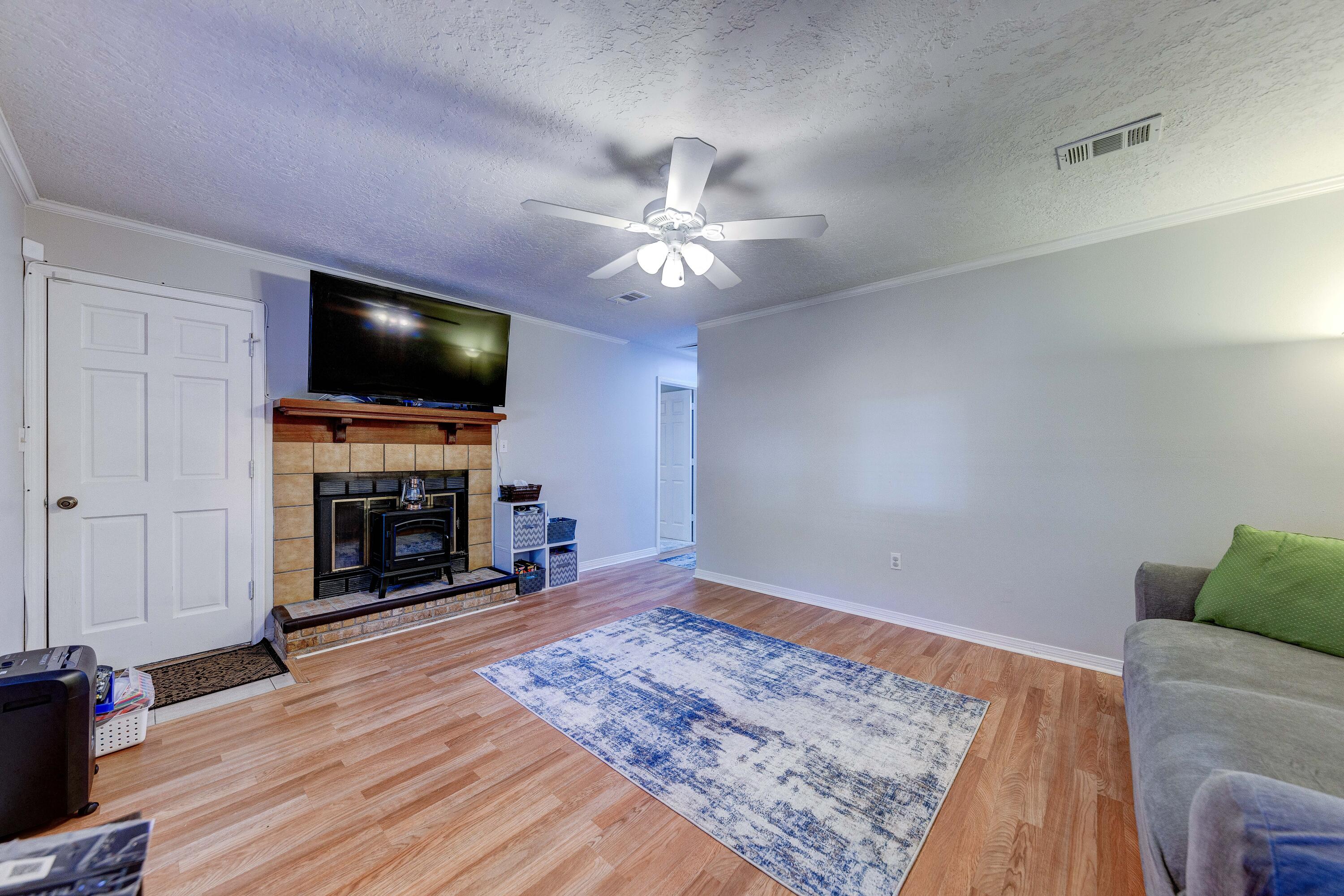 104 Fairoaks Drive Crestview, FL 32539 - Photo 5 of 24 a living room with fireplace and a flat screen tv