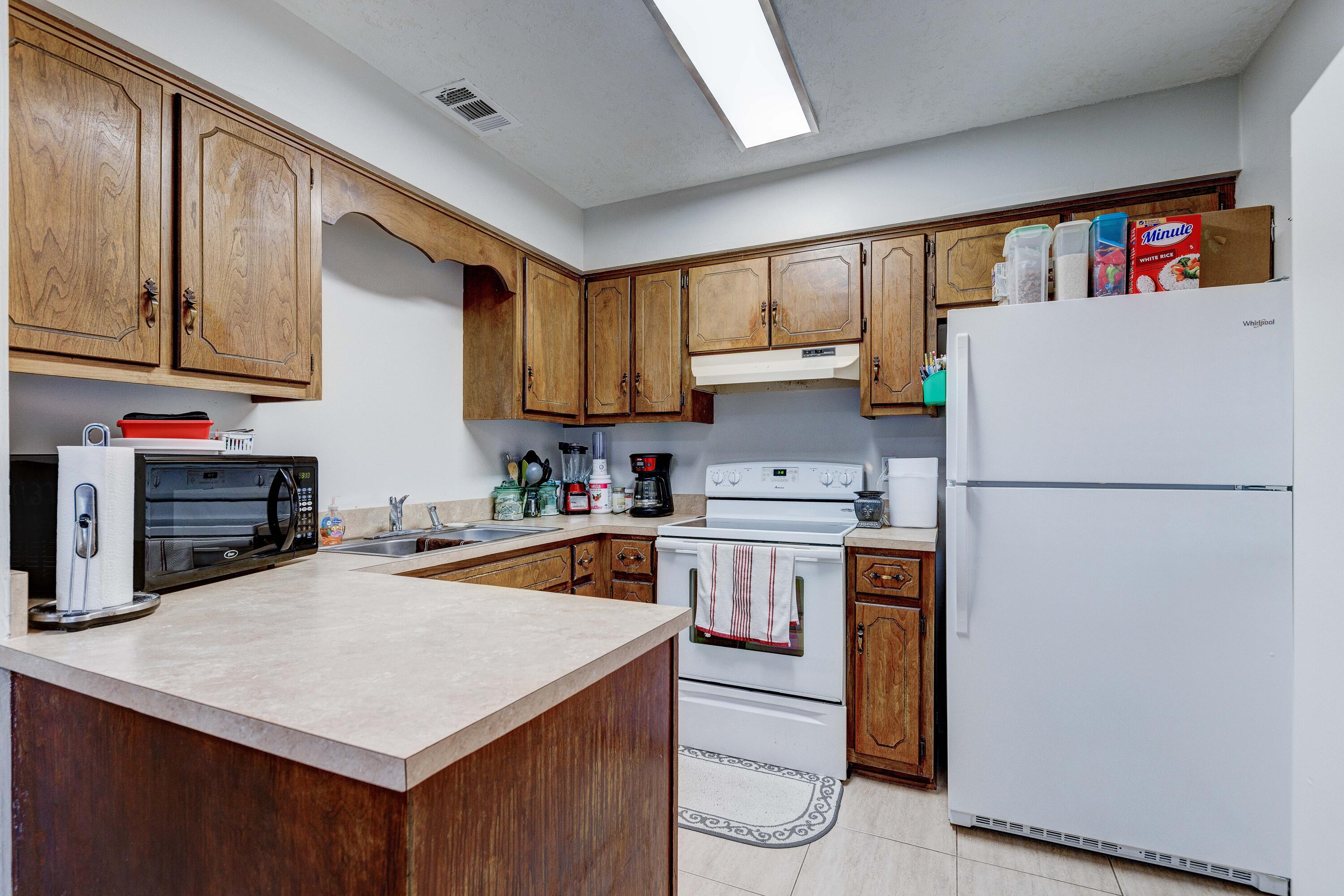 104 Fairoaks Drive Crestview, FL 32539 - Photo 8 of 24 a kitchen with a refrigerator a stove a sink and cabinets