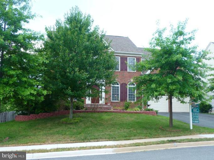 6089 Deer Ridge Trail Springfield, VA 22150 - Photo 2 of 30 a front view of a house with a garden