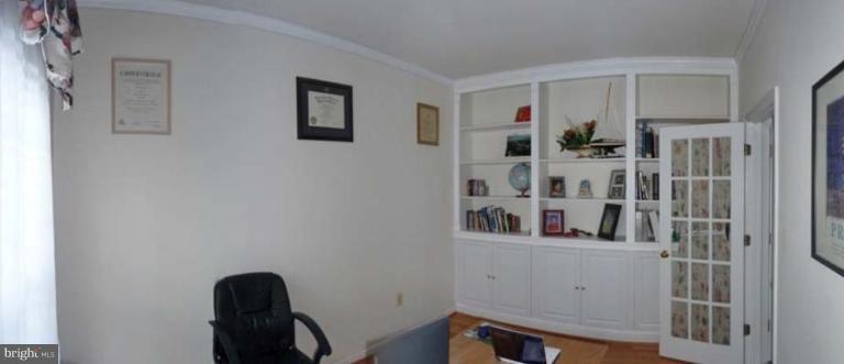 6089 Deer Ridge Trail Springfield, VA 22150 - Photo 13 of 30 a hallway with white cabinets and wooden floor