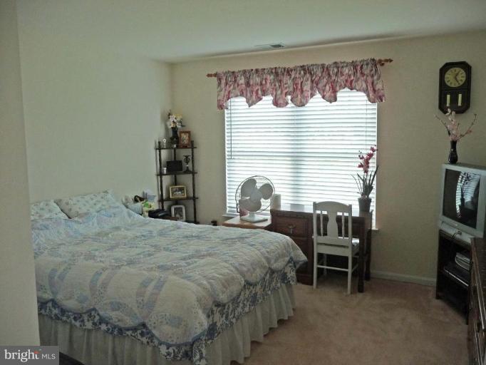 6089 Deer Ridge Trail Springfield, VA 22150 - Photo 20 of 30 a bedroom with a bed and a window