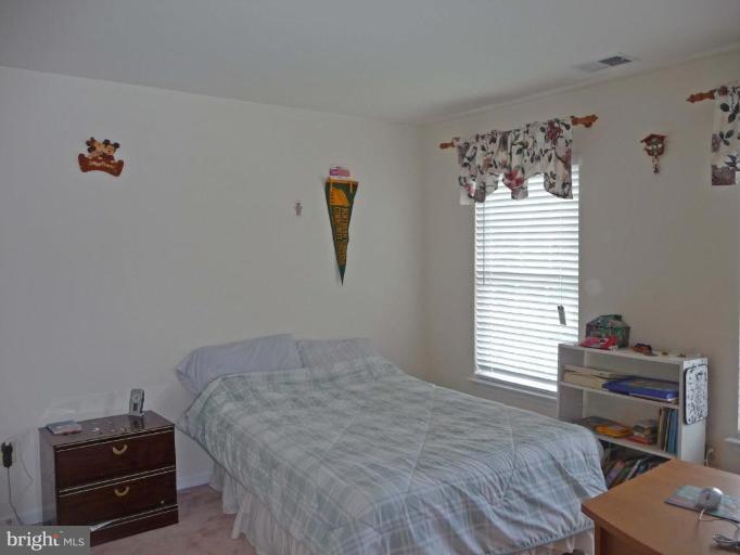 6089 Deer Ridge Trail Springfield, VA 22150 - Photo 22 of 30 a bedroom with a bed and a window