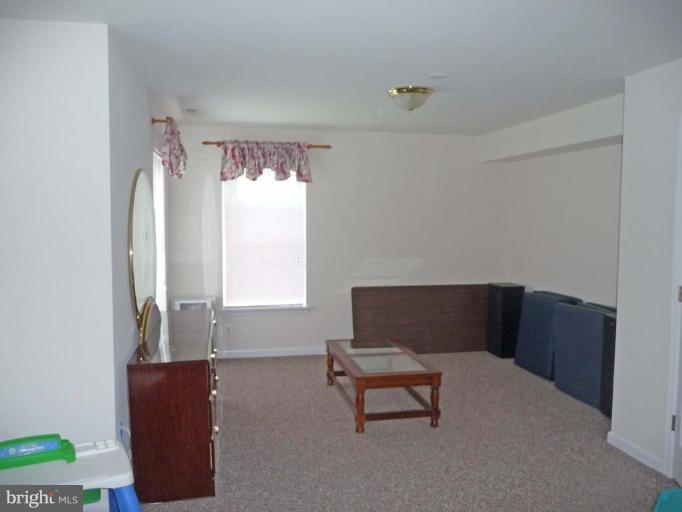 6089 Deer Ridge Trail Springfield, VA 22150 - Photo 24 of 30 a living room with furniture and a window