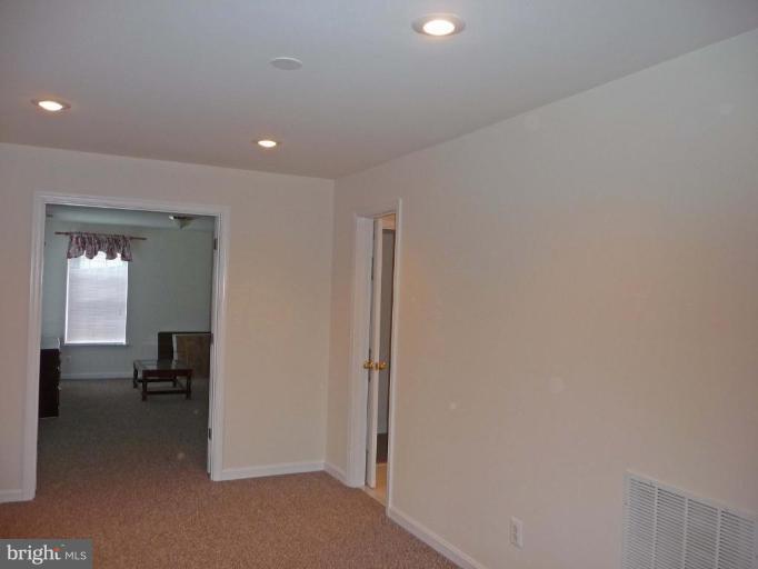 6089 Deer Ridge Trail Springfield, VA 22150 - Photo 28 of 30 a view of a livingroom and a hall with wooden floor