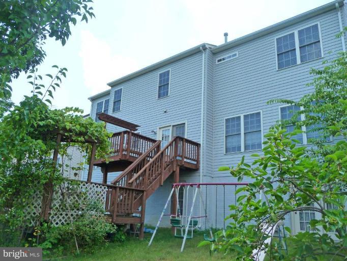 6089 Deer Ridge Trail Springfield, VA 22150 - Photo 30 of 30 a view of a house with wooden stairs and a fence