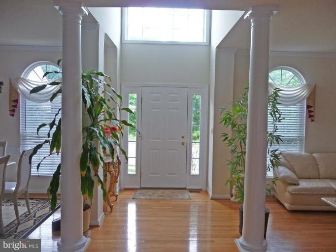 6089 Deer Ridge Trail Springfield, VA 22150 - Photo 4 of 30 a view of a hallway with couches and a potted plant