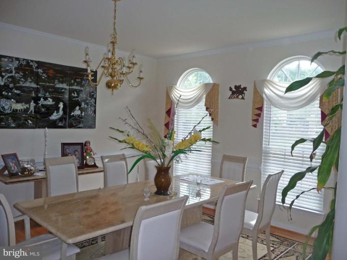6089 Deer Ridge Trail Springfield, VA 22150 - Photo 6 of 30 a view of a dining room with furniture and chandelier