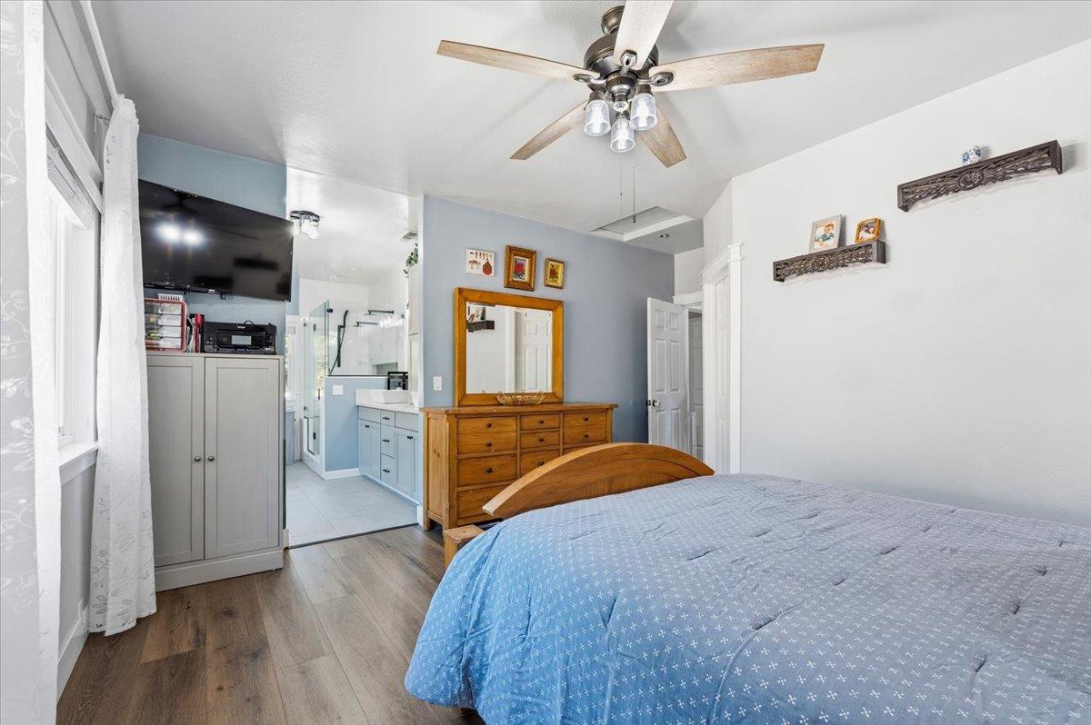 10784 Cole Way Grass Valley, CA 95945 - Photo 22 of 57 a bedroom with a bed and a chandelier